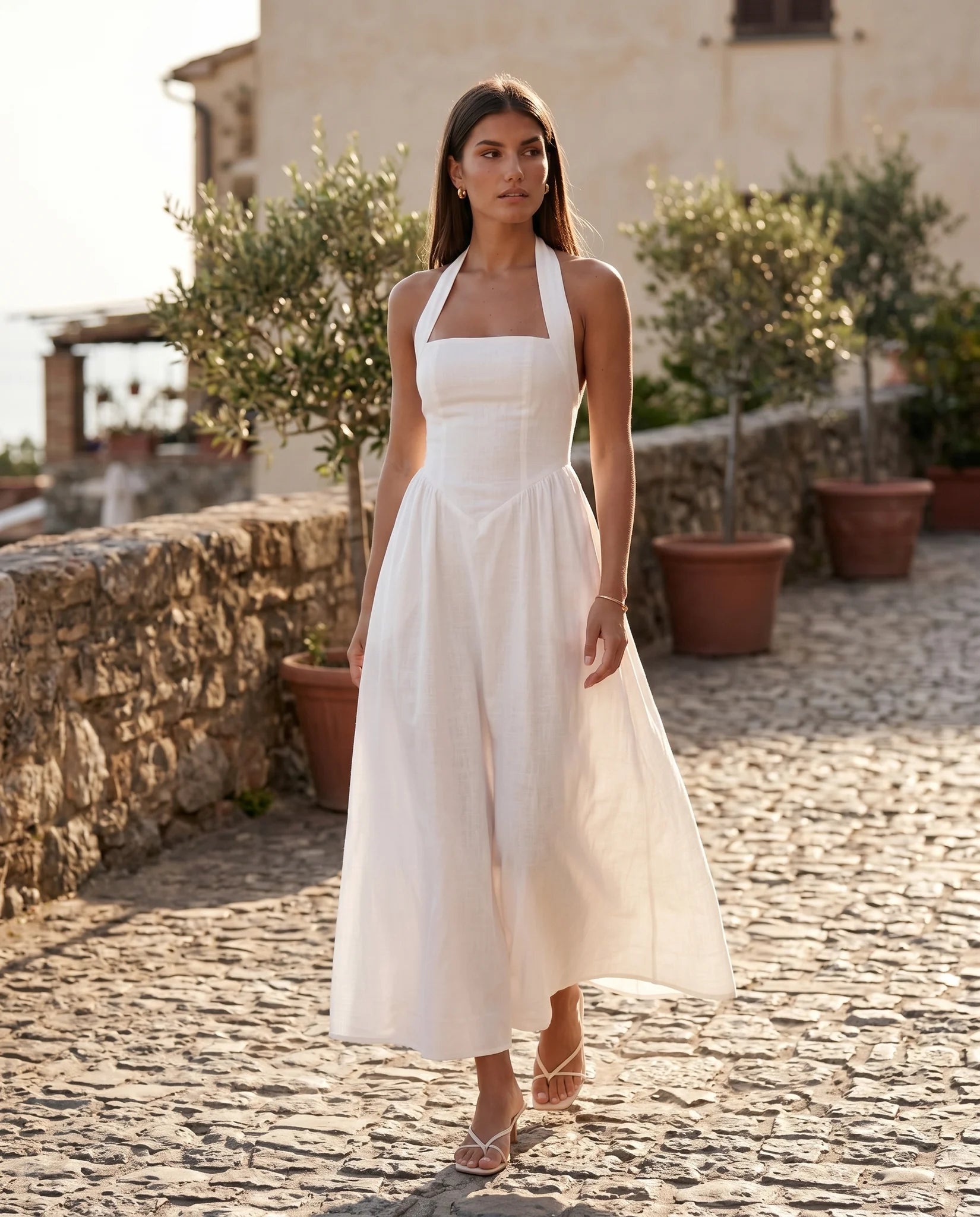Aurora Basque Waist Halter Maxi Dress in White — lifestyle movement view