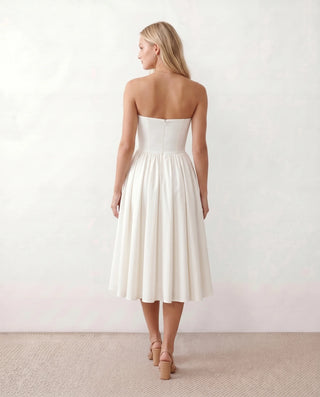 Vicenta Basque Waist Strapless Midi Dress in White — back view