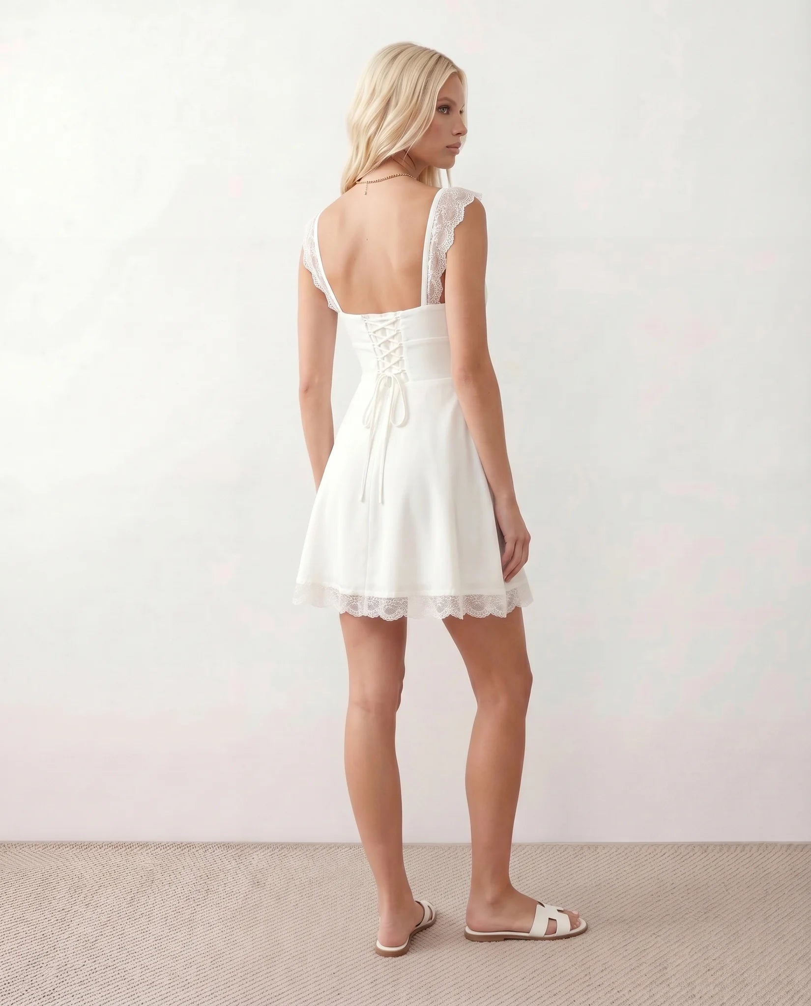 Soraia Lace Lace-Up Mini Dress in White — back view