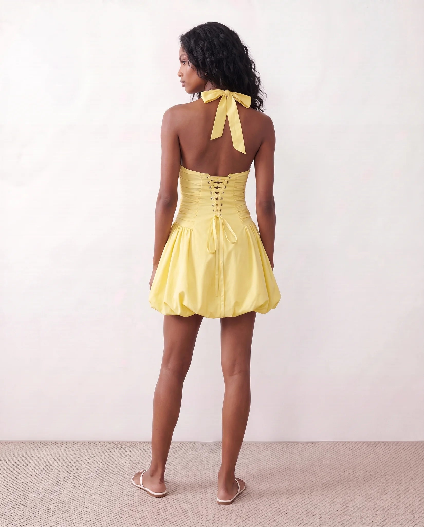 Ivana Halter Plunge Neck Mini Dress in yellow — back view